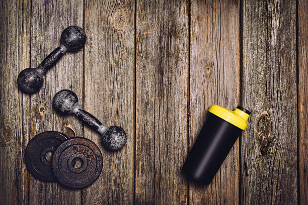 istock Fitness workout background. Dumbbells on wooden floor 612850232