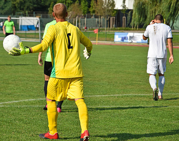 istock Soccer goalkeeper throws out the ball 612850854