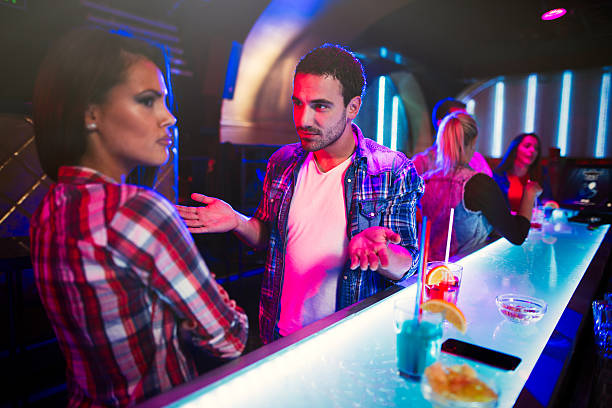 istock Young couple arguing in a nightclub 612852076