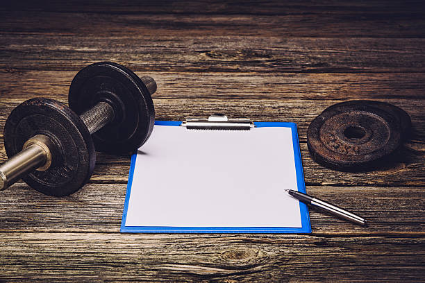 istock Fitness training plan or diet. Blank paper page 612852478