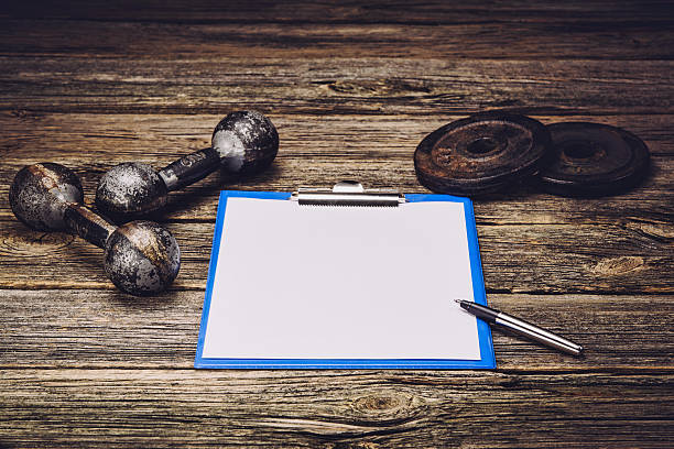 istock Fitness training plan or diet. Blank paper page 612852534