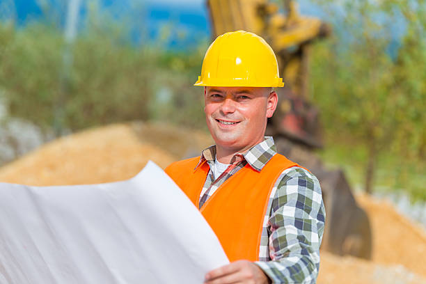 istock Portrait of an Earth Digger Driver with blueprint in hand 612852954
