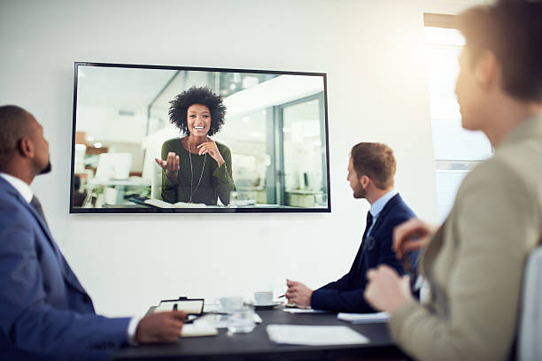 Nothing is lost in translation thanks to video calling Shot of a diverse team of colleagues having a video conference in a modern office conference call stock pictures, royalty-free photos & images
