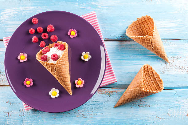 istock Raspberries and cottage cheese in ice cream cone. Children's breakfast 612855974