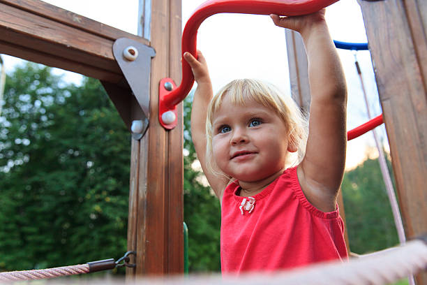 istock little girl playing on monkey bars, kids sport 612856204