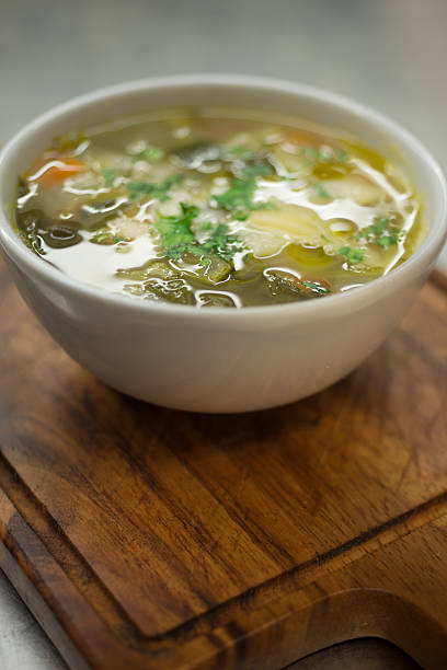 istock Bowl of Soup on a Wooden Board 612856534