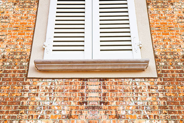 istock New wooden window against a brick wall with stone windowsill 612856592