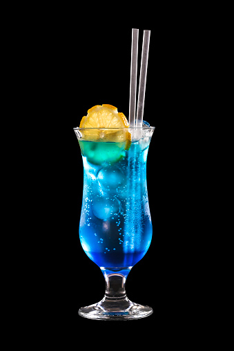Blue Lagoon is a popular summer cocktail featuring blue Curacao, isolated on black background.