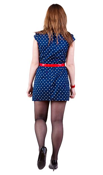 istock back view of walking young  woman 612857838