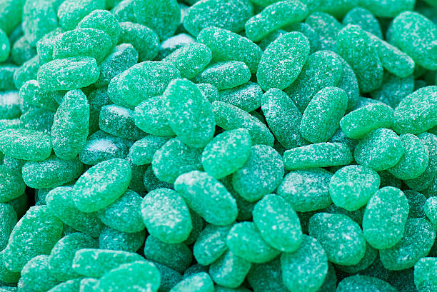 istock Green jelly mint candies sprinkled with sugar 612858516