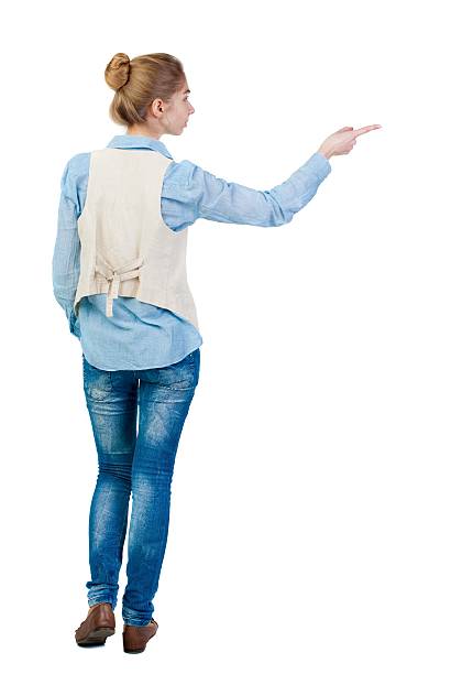 istock Back view of  pointing woman. 612859638