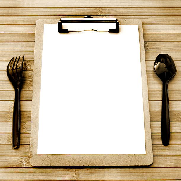 istock Paper menu on wooden table copy space vintage style 612859748