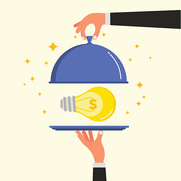 istock Businessman hands opening cloche lid cover with light bulb 612860188