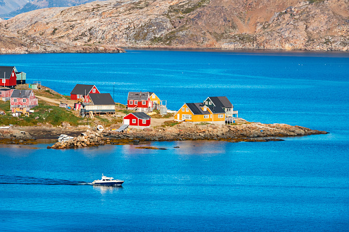 Photo of colorful houses and a boat in remote Kulusuk, located on Kulusuk Island in eastern Greenland.