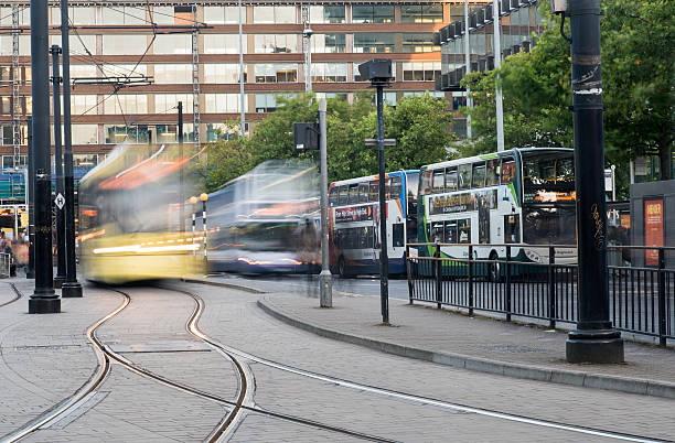Manchester, United Kingdom - September 23, 2016: Piccadilly central bus and metro station with moving tram and buses in Piccadilly gardens at the city of Manchester in England