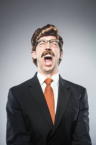 Angry CEO Yelling A corporate manager type business man in full suit, big combover hairstyle and mustache screams in anger and rage at bad news or business failure.  Intentional cliche look for humor.  Vertical portrait. comb over stock pictures, royalty-free photos & images