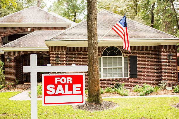 istock House for sale sign in front yard. 613013084