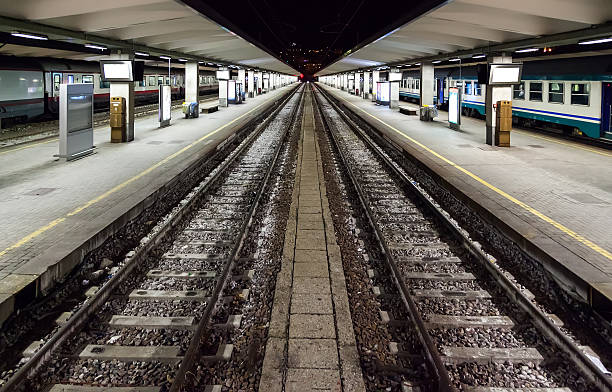 istock Empty railway platform at night in the high-speed station 613013490