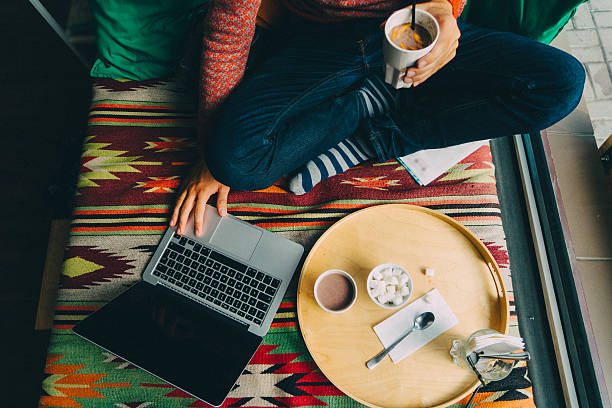 istock Man with laptop and cacao drink 613013798