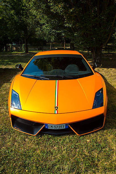 Kiev, Ukraine; July 1, 2012; Lamborghini Aventador on the streets. Car. Orange. City. Luxurious. Tuning. Supercar. The car in the rain. Raindrops