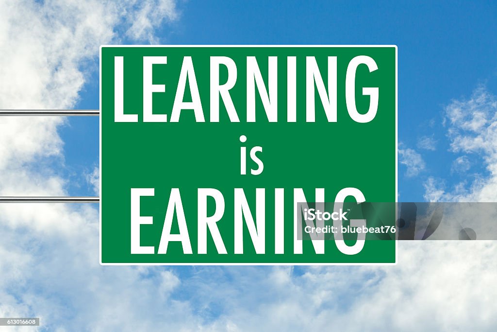 Learning is earning green road sign Learning is earning green road sign over blue sky background. Concept road sign collection. Advertisement Stock Photo