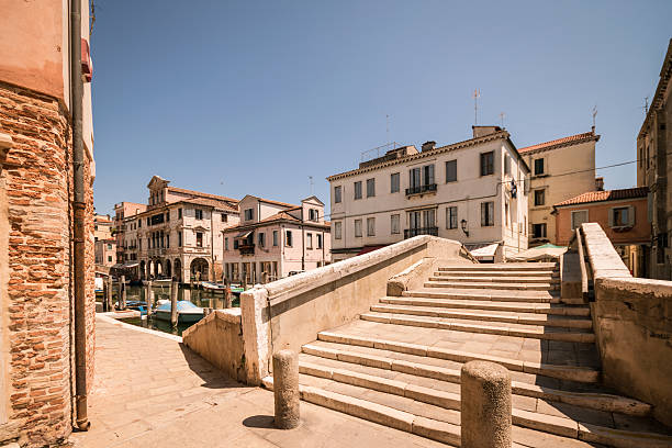 istock Typical bridge across a canal in Chioggia, Venice, Italy. 613017546