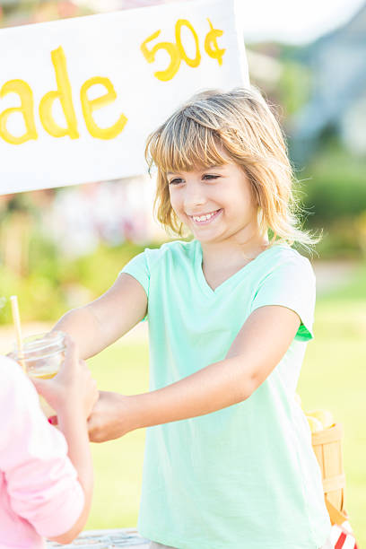istock Excited girl hands lemonade to customer 613017830