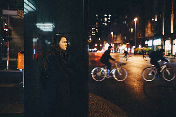 istock Young woman walking in Berlin at night 613017846