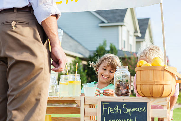 istock Girl serves lemonade at her lemonade stand 613017920