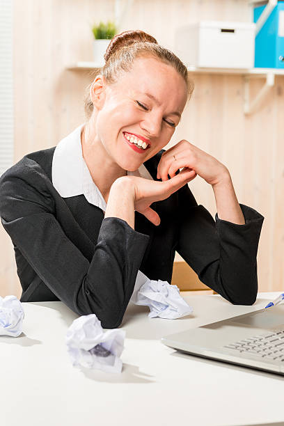 istock happy creative worker in the office, and crumpled paper 613019042