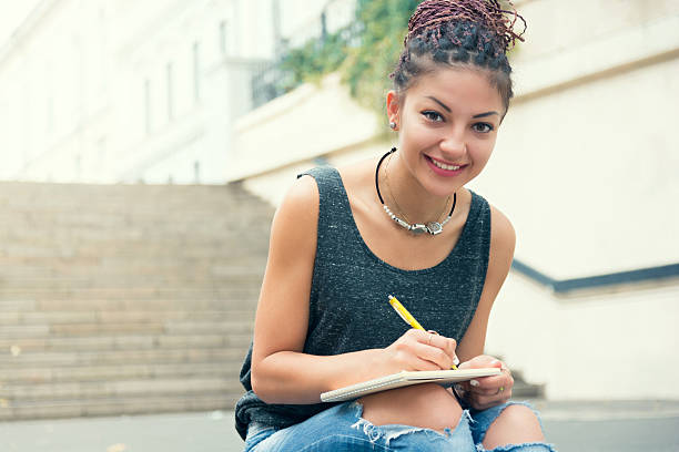istock Woman write down the notes at the street, smiling 613019812