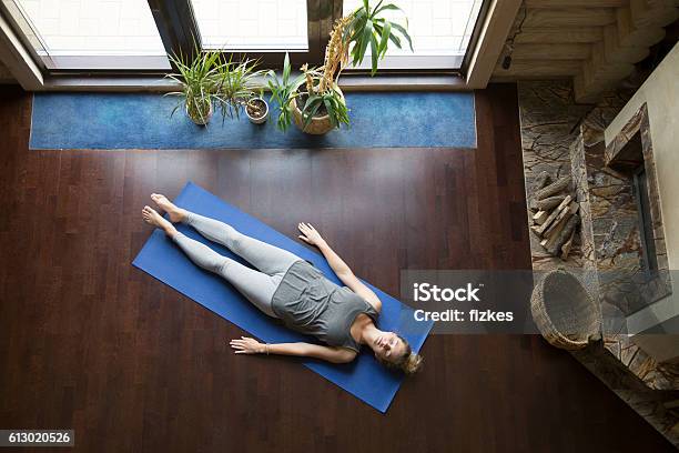 Yoga At Home Relaxation Stock Photo - Download Image Now - Shavasana, Buddhism, Domestic Room