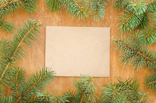 istock Frame made of fir branches and envelope for copyspace. 613020986