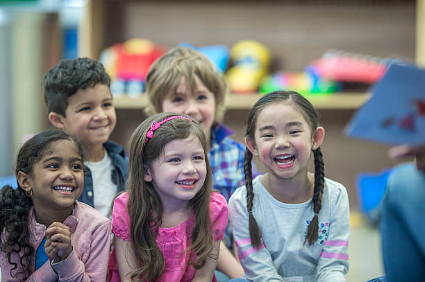 istock Listening to Their Teacher Read a Book 613021256