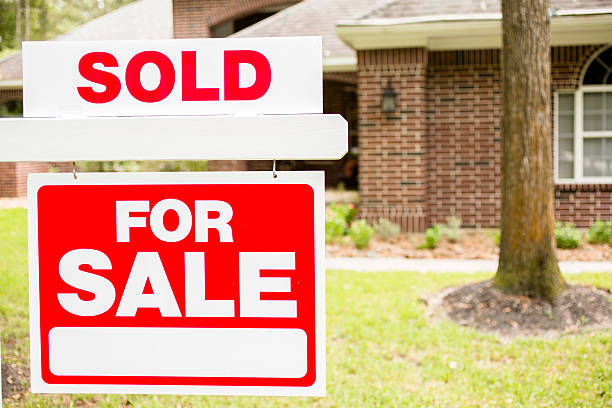istock House for sale sign in front yard. 613021286
