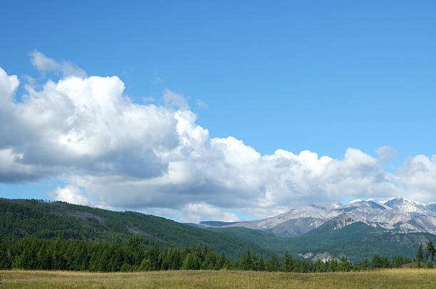 istock Blue sky and cumulus clouds over the Eastern Sayan Mountains 613022142
