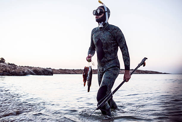 istock spear fisherman coming back from the sea 613023698