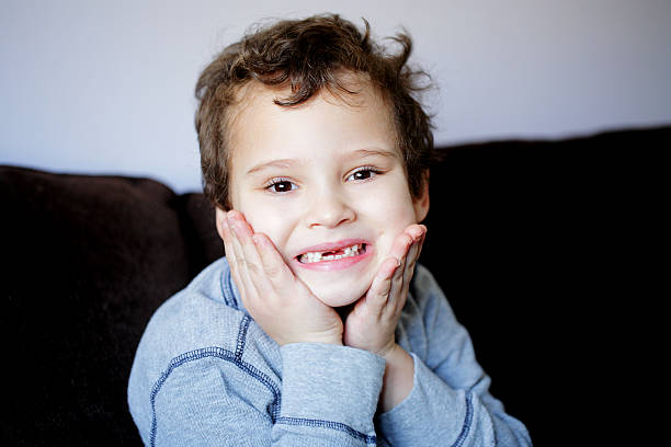 istock Portrait of a young boy with missing front teeth 613025002