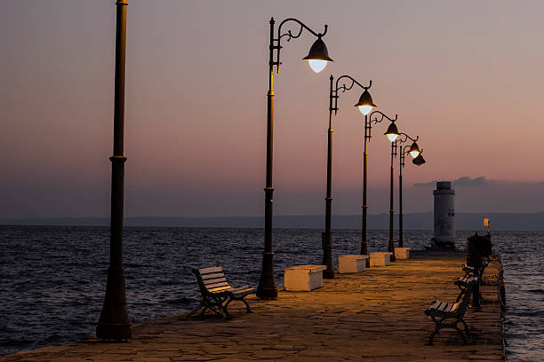istock The Beach pier with lamps at sunrise 613025094