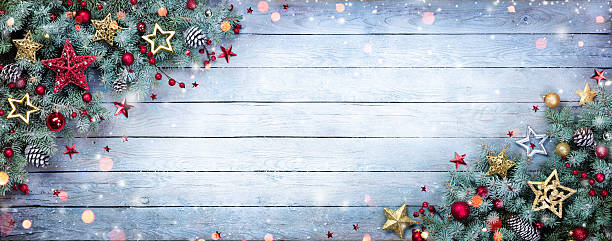 istock Fir Branches With Baubles On Wooden Plank 613027260