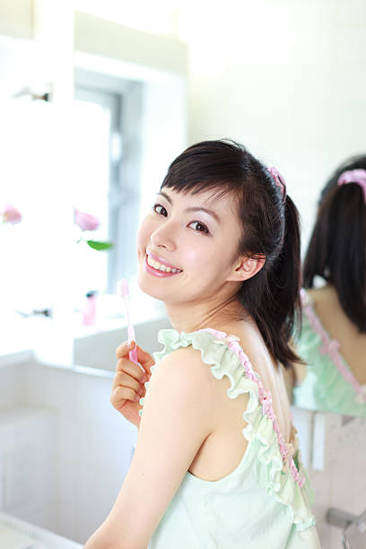 istock Japanese woman in front of a mirror 613027418