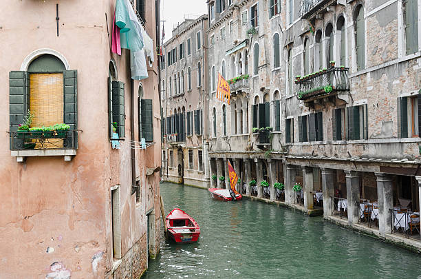 istock Venice channel and a red boat 613027948