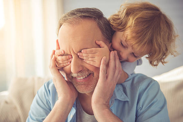 nonno e nipote maschio - grandfather adult affectionate little boys foto e immagini stock