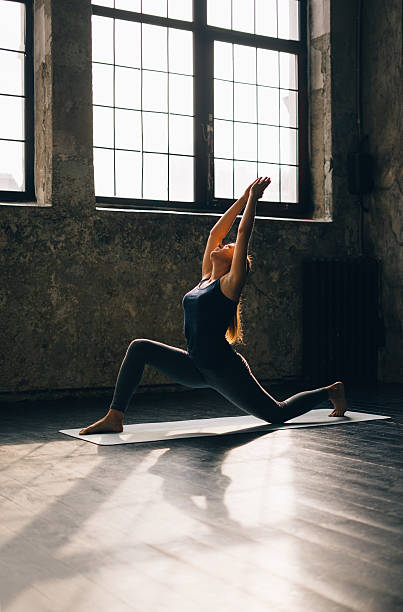 istock Young woman practicing yoga in an urban loft 613030004