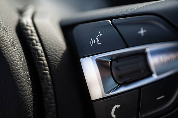 Buttons in a car Detail on some buttons on a car's steering wheel. vehicle interior audio stock pictures, royalty-free photos & images