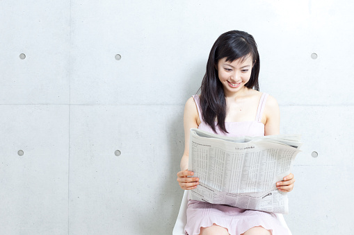 Japanese woman reading newspaper