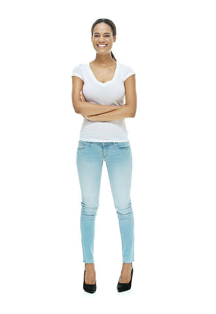 istock Smiling female standing with arms crossed 613030516
