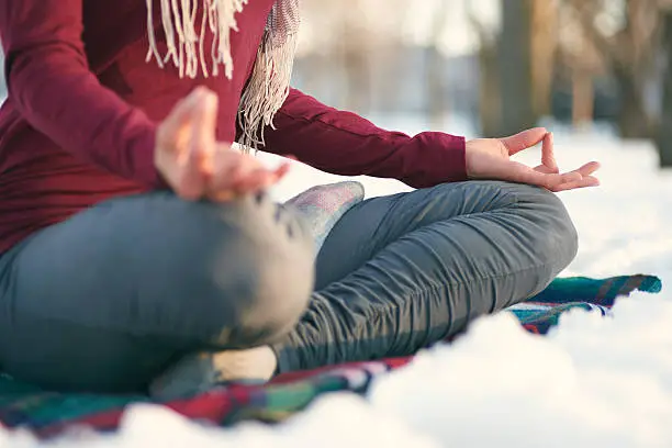 Photo of Attractive mixed race woman doing yoga in nature at winter