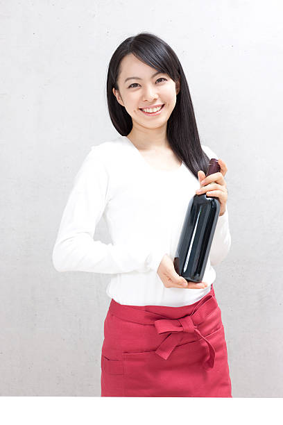 Japanese woman holding a red wine bottle