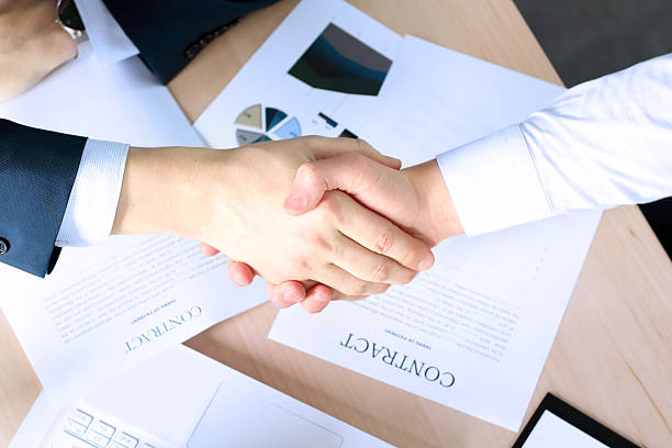 istock Firm handshake between two colleagues after signing a contract 613032852